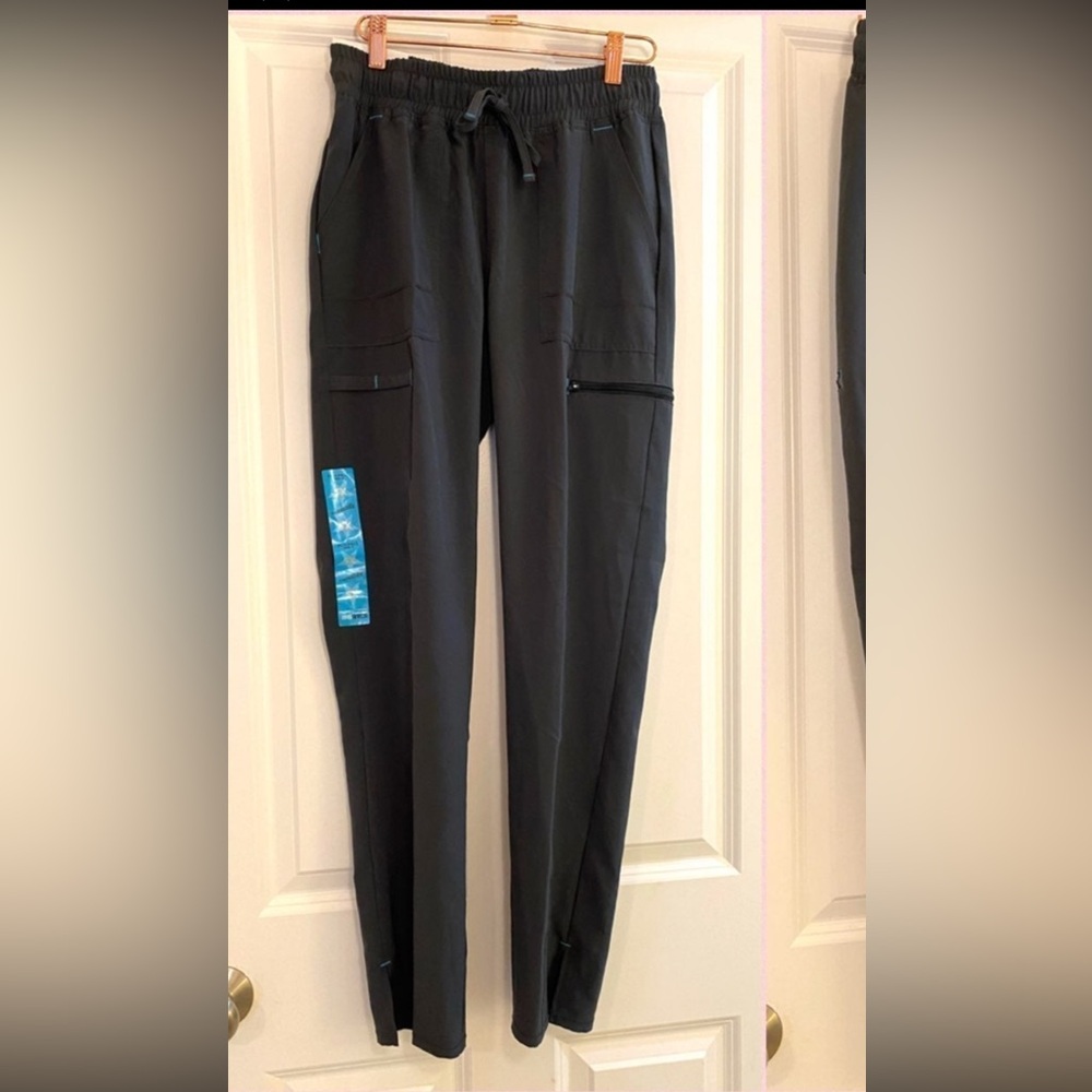 New with tags scrub star performance yoga pant in size xs. Pewter grey color